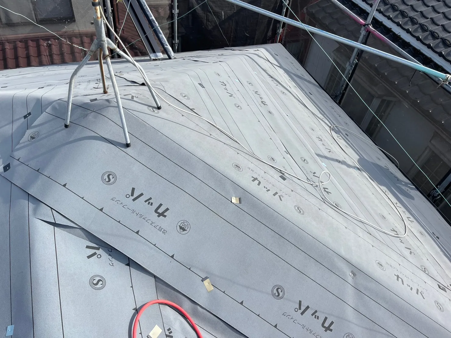 次にルーフィング（防水シート）を貼り付けていきます。屋根を一次防水・ルーフィングを二次防水とすることで屋根の信頼性を確保しています。